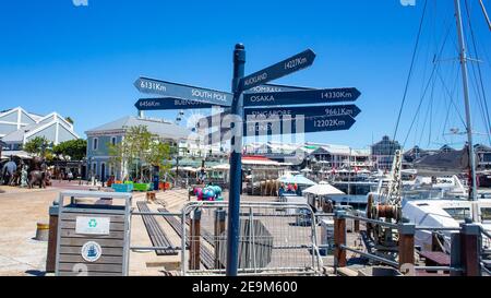 Waterfront- Cape Town, South Africa - 03-02-2021 Close up view of blue sign at the Waterfront. Sign points to different destinations around the world. Stock Photo