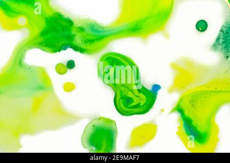 Liquid bright aquarel colours with oil generate fluid structures and bubbles in green, blue, yellow, white and gold Stock Photo
