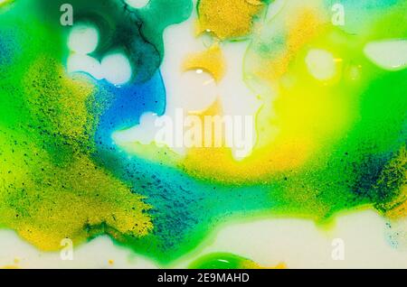 Liquid bright aquarel colours with oil generate fluid structures and bubbles in green, blue, yellow, white and gold Stock Photo