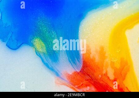 liquid bright aquarel colours with oil generate fluid structures and bubbles in red, orange, yellow, blue, white and pink Stock Photo