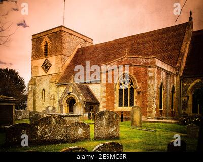A view of St Mary's church in Kintbury Berkshire from the graveyard with added texture and tones applied. Stock Photo