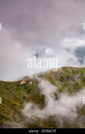 Isolated dwelling in the cloud covered mountains of Madeira, Portugal Stock Photo