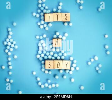 Its a Boy text written with wooden cubes with pastel blue background, Baby Shower or Nursery background Baby announcement. Flat lay,text space. top Stock Photo