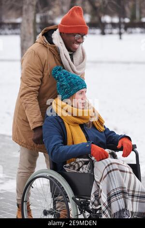 Happy young couple walking outdoors in winter day Stock Photo