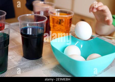 Child colouring easter eggs Stock Photo