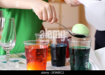 Child colouring easter eggs Stock Photo