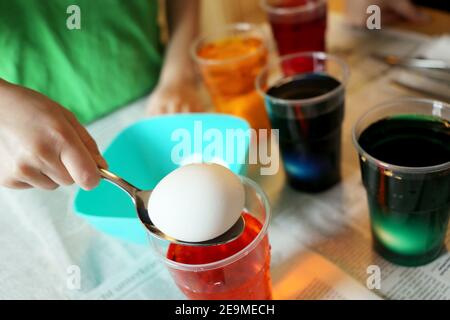 Child colouring easter eggs Stock Photo