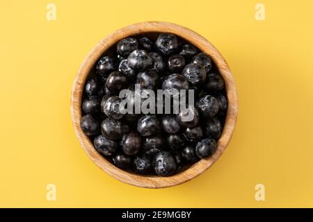 Fresh blueberries on yellow background Stock Photo
