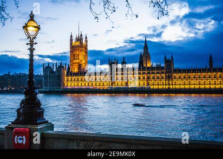 The Houses of Parliament along the river Thames in London at night. Stock Photo