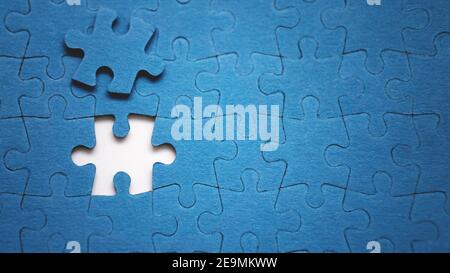 Top view flat lay of jigsaw puzzle with one piece missing .Concept of absence and incomplete.Putting the last piece finding solution Stock Photo