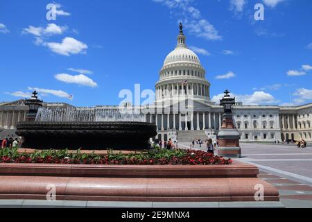 WASHINGTON DC, USA - JUNE 14, 2013: People walk by US National Capitol in Washington DC. 18.9 million tourists visited capital of the United States in Stock Photo