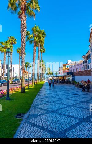 CASCAIS, PORTUGAL, MAY 31, 2019: People are strolling through narrow streets of Cascais in Portugal Stock Photo