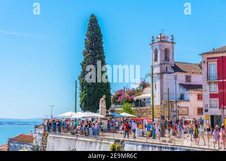 LISBON, PORTUGAL, JUNE 1, 2019: People are admiring Alfama district in Lisbon from Santa Luzia viewpoint, Portugal Stock Photo