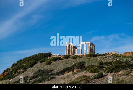Greece Cape Sounio, Poseidon temple. Archaeological site of ancient greek temple ruins up on the hill, Athens Attica. Clear blue sky backgrpund, sunny Stock Photo