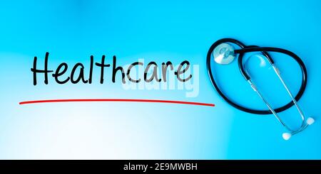 Healthcare Sign.Text underline with red line. Isolated on blue background with stethoscope. Health concept Stock Photo