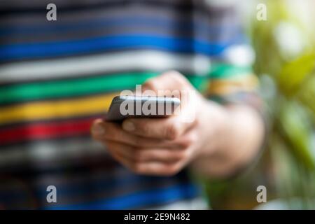 Male hands typing on smartphone Stock Photo