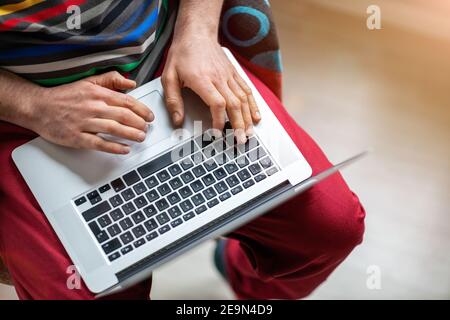 Cropped shot of an unrecognizable man using a laptop at home Stock Photo