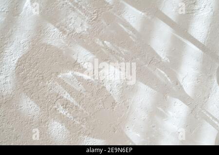 White concrete like background texture with shadows from Venetian blinds and glasses, with copy space Stock Photo