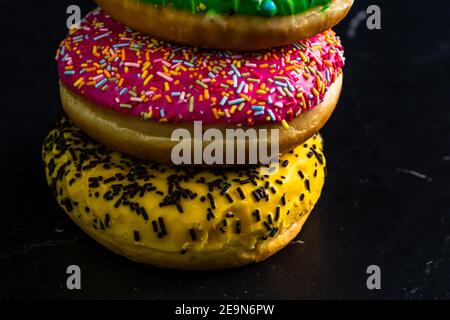 Glazed donuts with sprinkles isolated. Close up of colorful donuts. Stock Photo