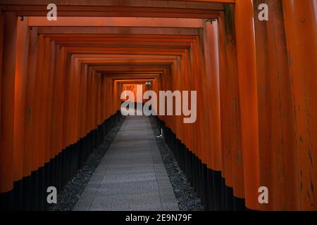 Beautiful and peaceful Fushimi Inari shrine near Kyoto, Japan.  Tunnel of red torii gates. Stock Photo