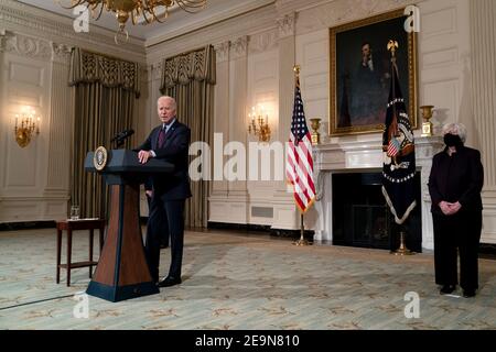 United States Secretary of the Treasury Janet Yellen, right, listens as US President Joe Biden speaks about the economy in the State Dining Room of the White House in Washington on Friday, February 5, 2021.Credit: Stefani Reynolds/Pool via CNP | usage worldwide Stock Photo