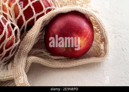 Fresh apples in an ecological reusable net bag made of organic cotton, close up Stock Photo