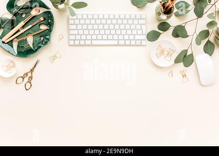 Flat lay home office desk. Female workspace with computer, plate sheet  monstera, golden accessories, eucalyptus leaves, on beige background. Top  view Stock Photo - Alamy