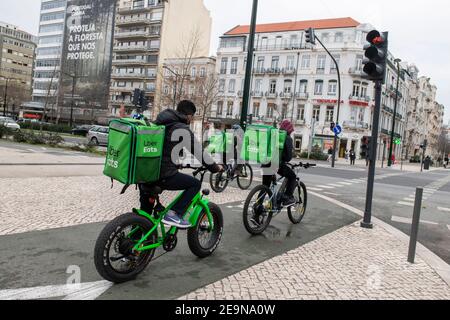 Uber Eats couriers are seen waiting at the traffic light in Lisbon 