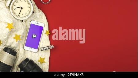 Kharkov, Ukraine - February 5, 2021: smartphone apple with video streaming service Twitch application, creative flat lay background banner, copy space Stock Photo