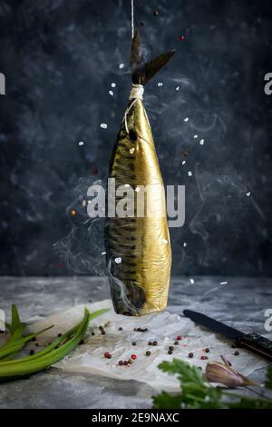 Smoked mackerel of cold smoked. Smoked Fish In Smokehouse Box. Close Up Smoking Process Fish For Home Use. Smoked Mackerel, Preparation Of Organic Foo Stock Photo