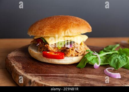Fresh Pulled pork sandwich with pickled cucumber, arugula and jalapenos Stock Photo