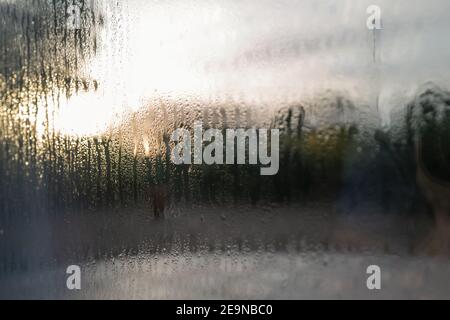 Condensation on the outside of double glazed window glass at sunrise Stock Photo