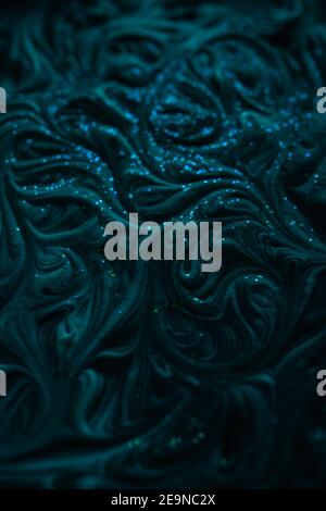 Smooth marbling mixed liquid paint texture with glitter. Abstract drammatic dark texture with fluid art effect Stock Photo