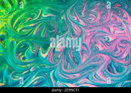Liquid marble background. Vibrant fluid art texture. Light trendy modern background at vibrant green and pink colors. Volume relief with colorful aqry Stock Photo
