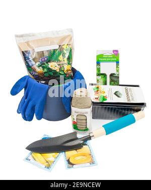 Vertical shot of a group of gardening objects in preparation for planting on a white background. Stock Photo