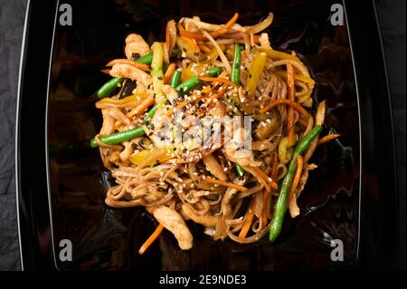 Udon with Fried Fillet of Chicken and Vegetables Stock Photo