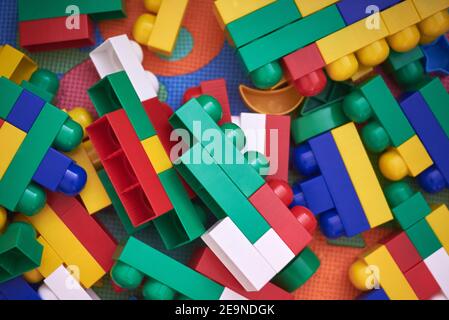 Children's large multi-colored constructor scattered on the floor. Stock Photo