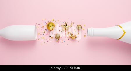 Creative layout with Champagne bottle and Champagne glass. Minimal New Year greeting card party pink background. Flat lay composition. Stock Photo
