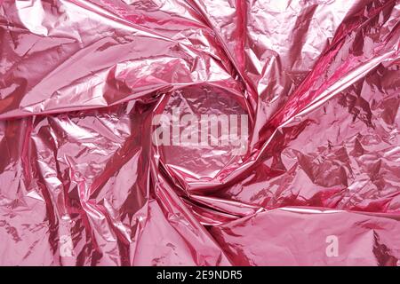 Abstract pink crumpled foil background. Minimal party concept. Stock Photo