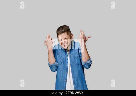 Happy handsome man crosses fingers and wins online bet and making crazy emotions. Caucasian man looks into the phone . Isolated white backround. Onlin Stock Photo