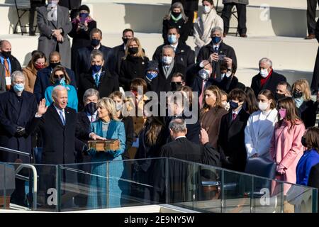 U.S President Joe Biden, joined by First Lady Dr. Jill Biden, Ashley Biden, Hunter Biden and their grandchildren, is sworn in as President of the United States by Supreme Court Chief Justice John Roberts during the 59th Presidential Inauguration ceremony at the U.S. Capitol Building January 20, 2021 in Washington, DC. Stock Photo