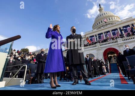 U.S Vice President Kamala Harris, joined by her husband Doug Emhoff, is sworn in as Vice President of the United States by Supreme Court Associate Justice Sonia Sotomayor during the 59th Presidential Inauguration ceremony at the U.S. Capitol Building January 20, 2021 in Washington, DC. Stock Photo