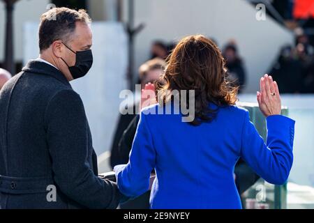 U.S Vice President Kamala Harris, joined by her husband Doug Emhoff, is sworn in as Vice President of the United States by Supreme Court Associate Justice Sonia Sotomayor during the 59th Presidential Inauguration ceremony at the U.S. Capitol Building January 20, 2021 in Washington, DC. Stock Photo