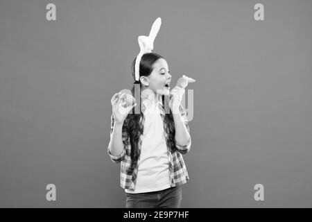 healthy traditional food. Funny decoration. little girl rabbit hold carrot. collecting painting eggs. happy easter. Easter Egg Hunt. Easter eggs and cute bunny. child wearing bunny ears on Easter day. Stock Photo