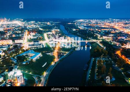 Grodno, Belarus. Aerial Bird's-eye View Of Hrodna Cityscape Skyline. Famous Popular Historic Landmarks In Night Lightning. Theater, Catholic Church Of Stock Photo