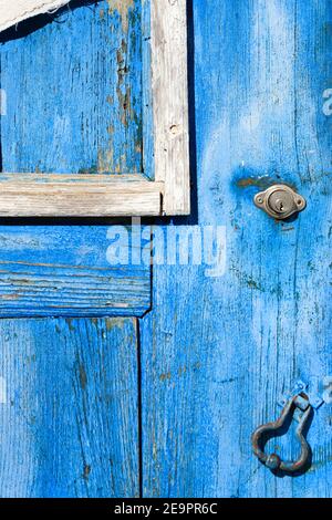 old wooden door covered with old cracked blue color paint Stock Photo