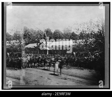 Mounted cavalry riding past reviewing stand during the ''grand review'' of the Union Army, Washington, D.C. Stock Photo