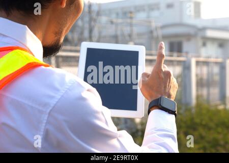 Engineer use tablet technology at power plant system Stock Photo