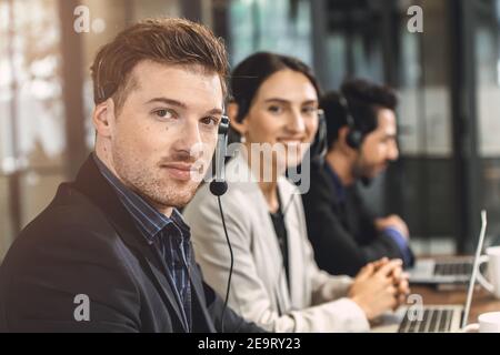 Operator teamwork happy smile, Business call center help desk service team working in office. Stock Photo