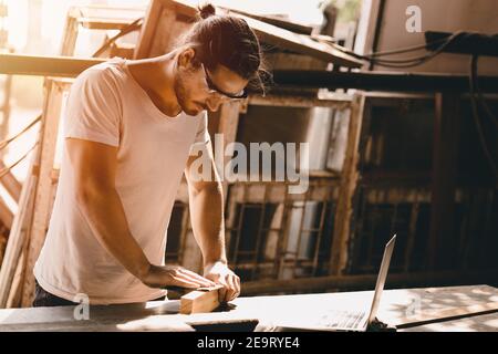 Carpenter man woodcraft working in furniture wood workshop with professional skill real people workman. Stock Photo
